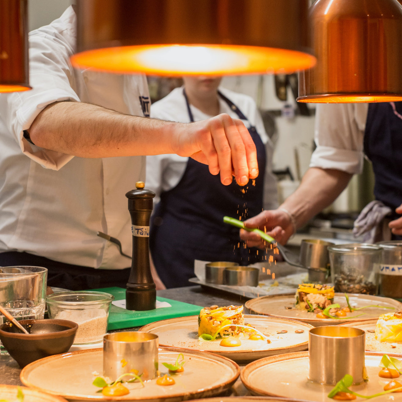 Professional chefs working with plant-based ingredients in a commercial kitchen
